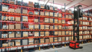 Linde very narrow aisle truck in use Linde very narrow aisle truck between racks
