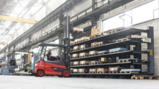 A Linde electric forklift truck stacking pallets in the warehouse Linde electric forklift truck stacking pallets